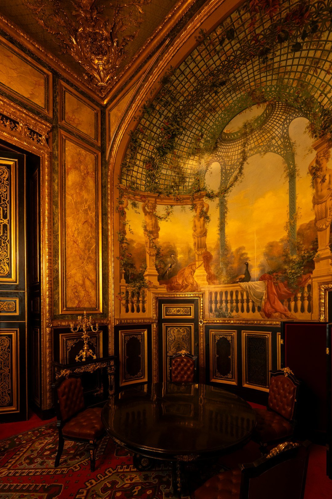 ornate-room-with-gilded-walls-and-painted-mural-xbvr0b6uzma
